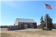 Front of Upland Barn with flag in the foreground