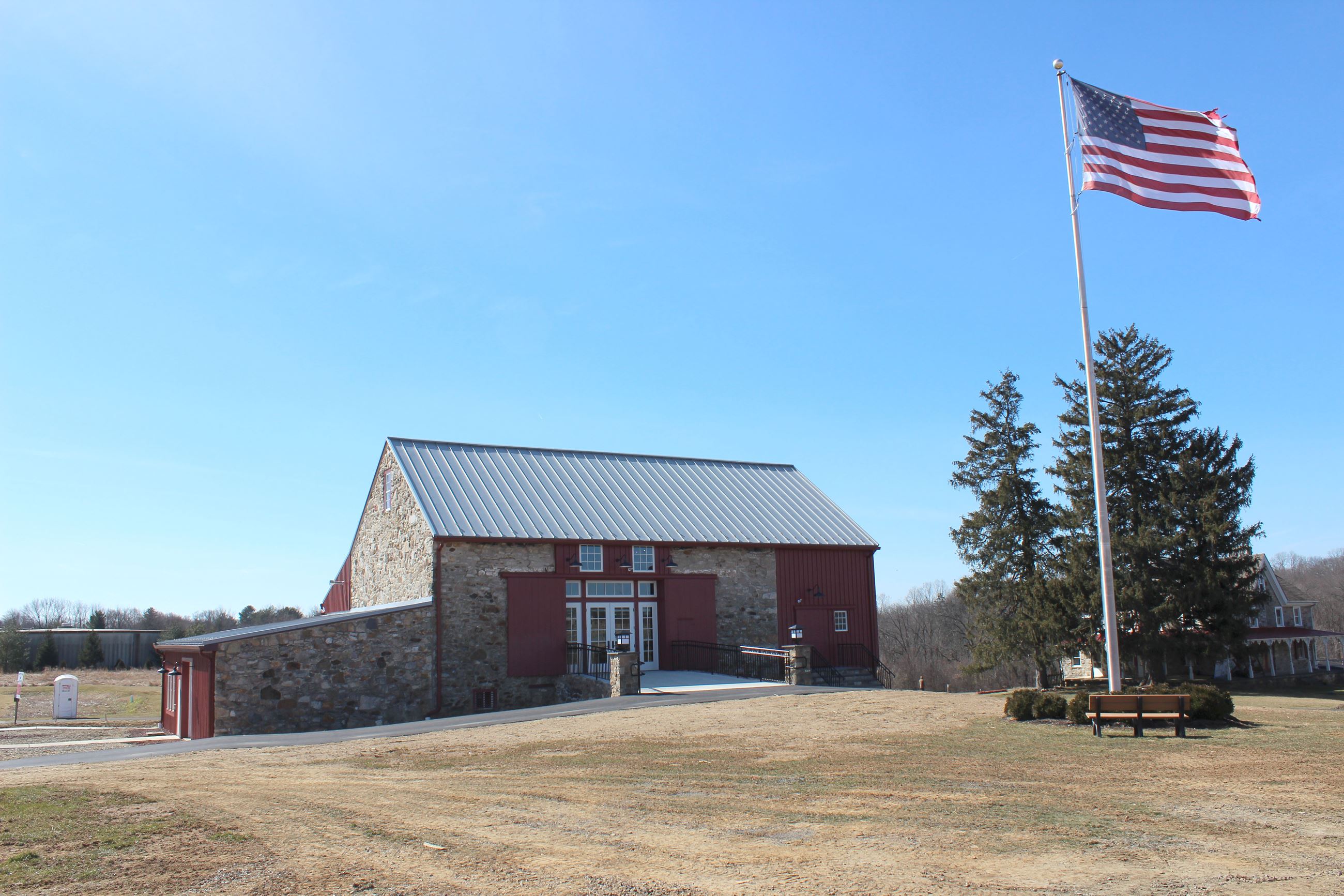 Front of Upland Barn with flag in the foreground