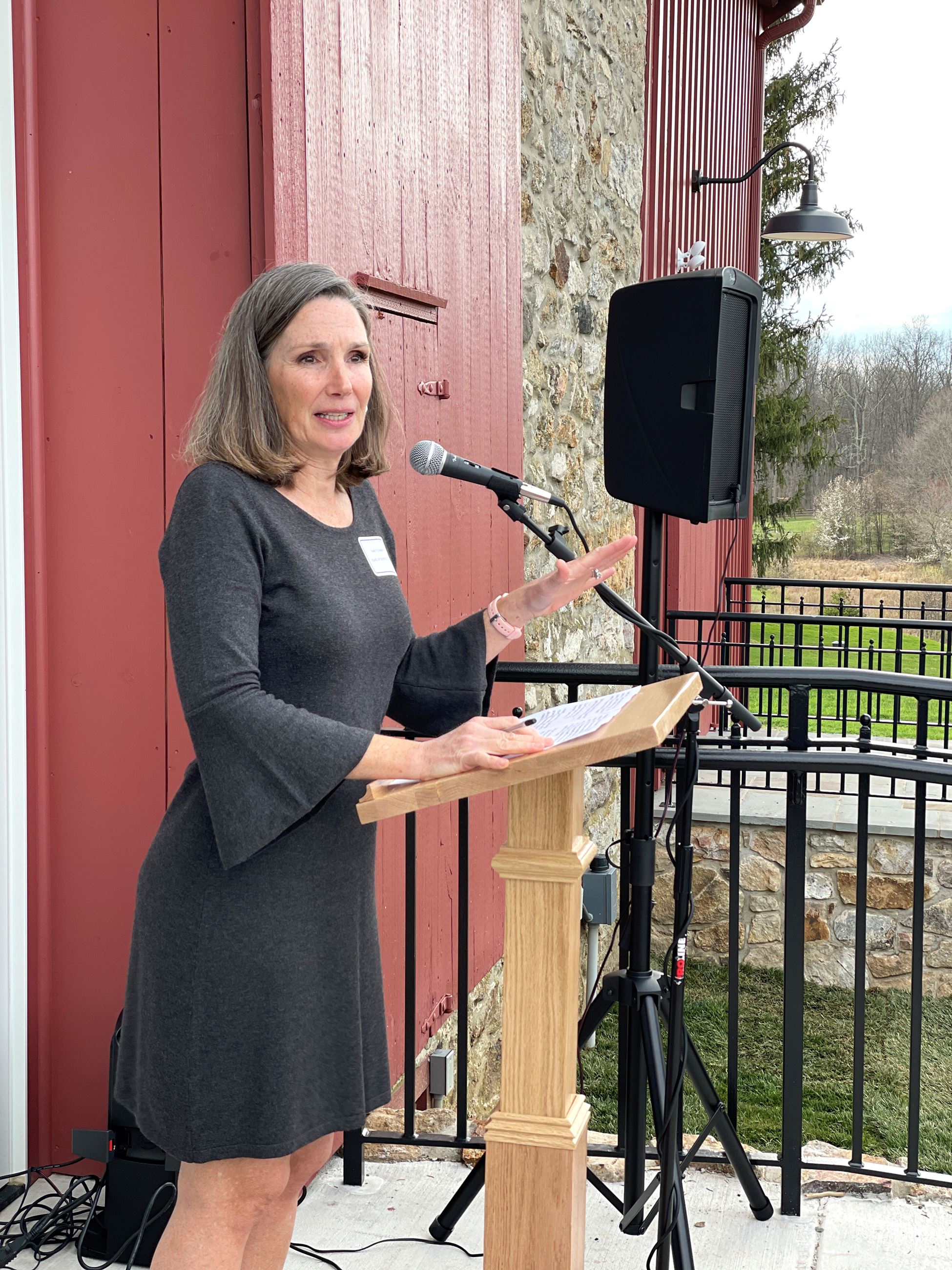 Sandy D'Amico speaks to the crowd at Barn ribbon cutting