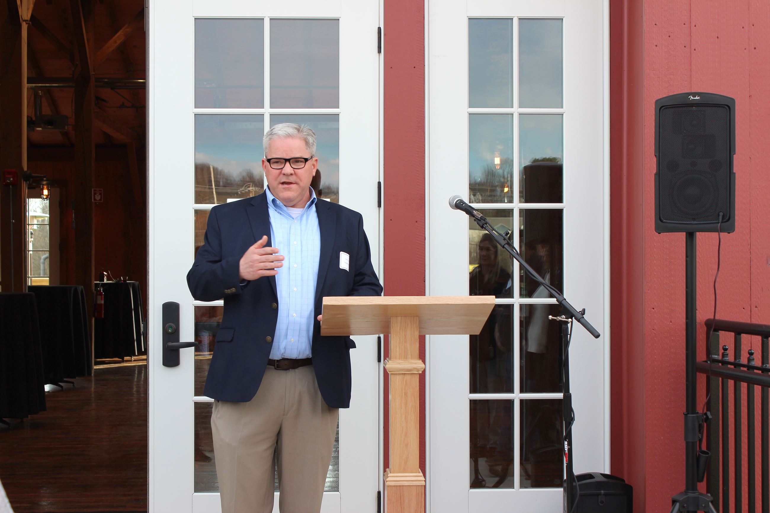 Tony Scheivert speaks to the crowd at Barn ribbon cutting